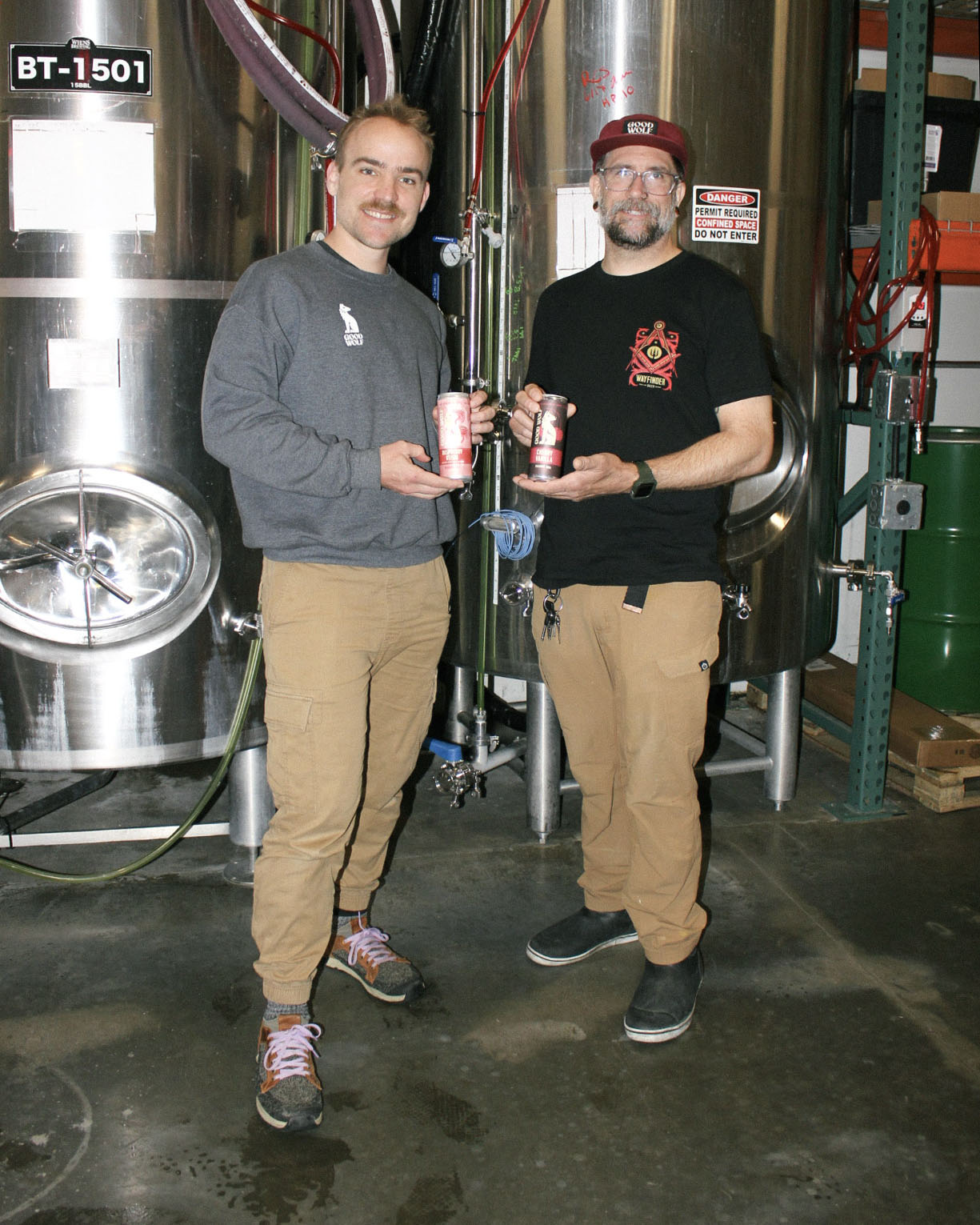 Nathan (left) and Sean (right) in the brewery, celebrating the latest batch of their handcrafted brew.