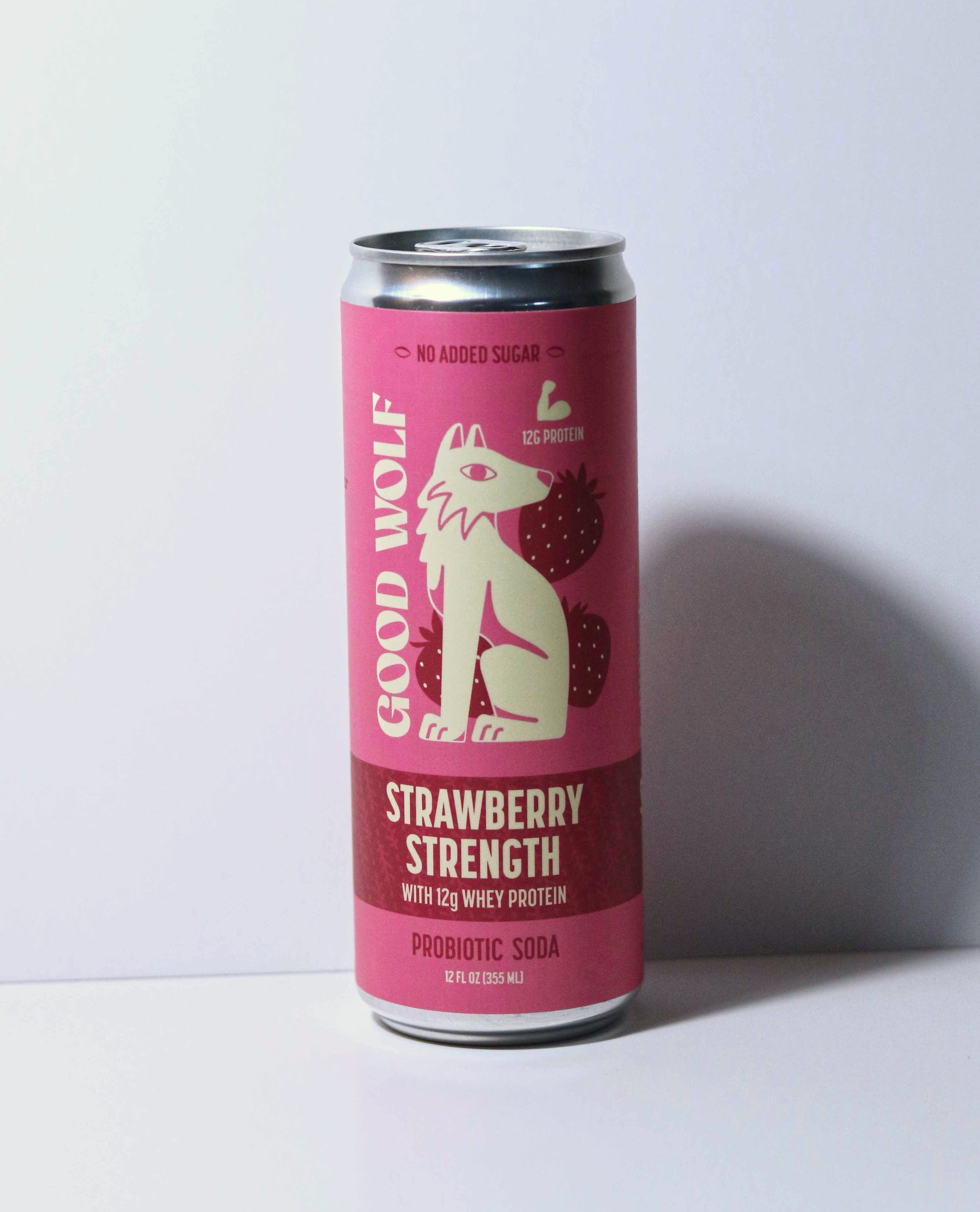 Pink can of 'Good Wolf Strawberry Strength' soda on a white background